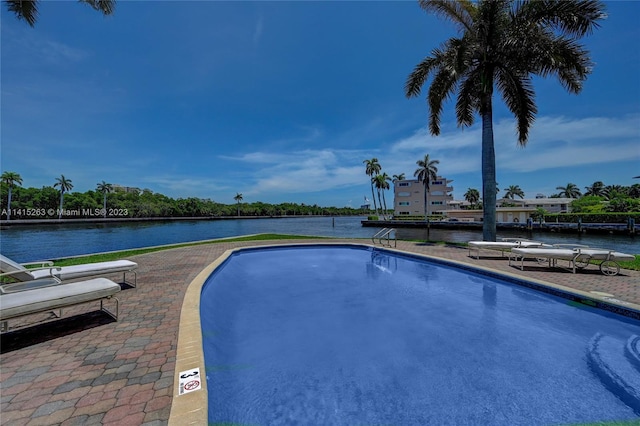 view of pool with a water view