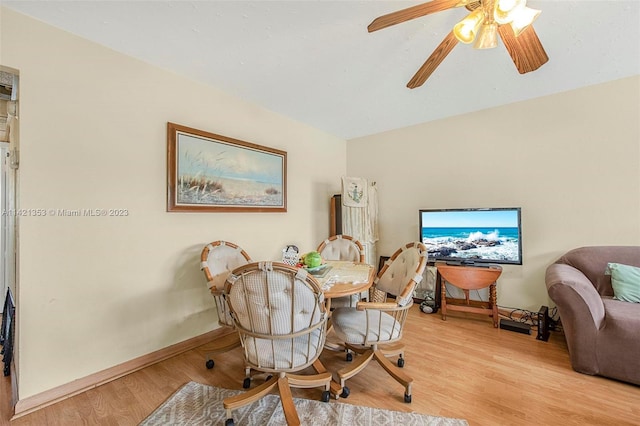 dining space with ceiling fan and light wood-type flooring