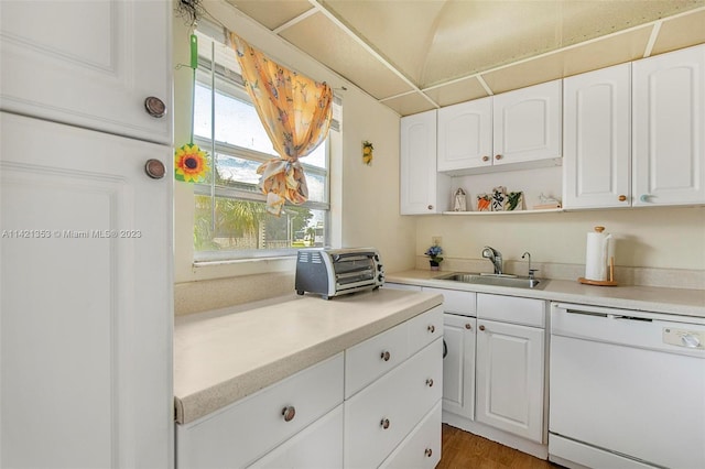 kitchen featuring white dishwasher, dark hardwood / wood-style flooring, white cabinetry, and sink