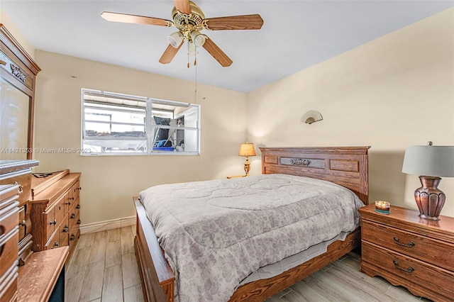 bedroom with ceiling fan and light hardwood / wood-style flooring