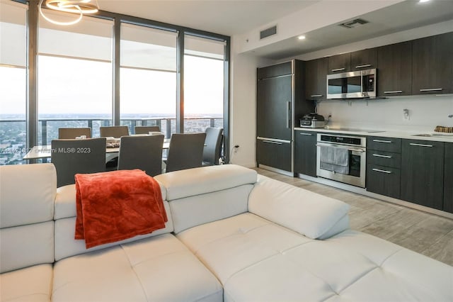 interior space featuring light hardwood / wood-style flooring and a wall of windows