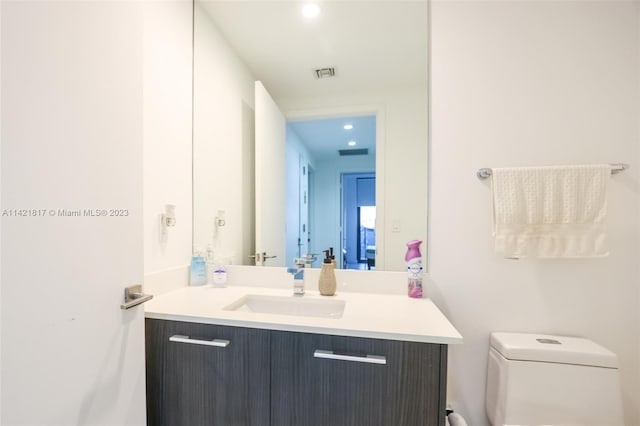 bathroom featuring vanity and toilet