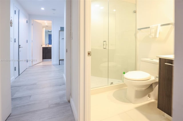 bathroom featuring hardwood / wood-style flooring, toilet, and vanity