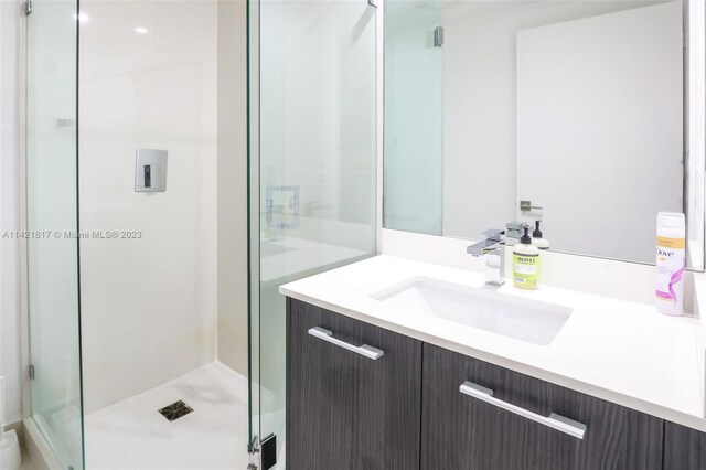 bathroom with walk in shower and vanity