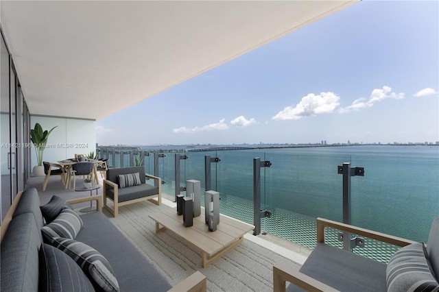 balcony featuring a water view and an outdoor hangout area