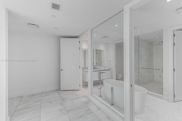 bathroom featuring vanity, tile patterned flooring, and separate shower and tub