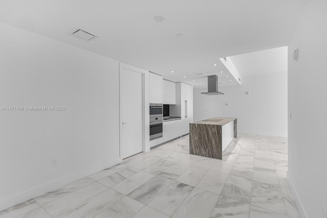 kitchen with light tile patterned flooring, white cabinets, a center island, black electric stovetop, and island range hood