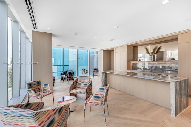 interior space with light parquet floors, expansive windows, and sink