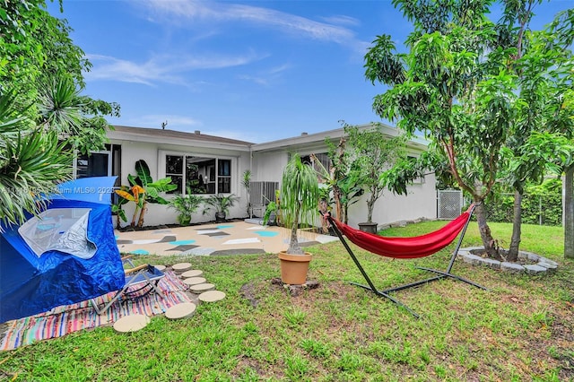 back of property featuring a patio area and a lawn