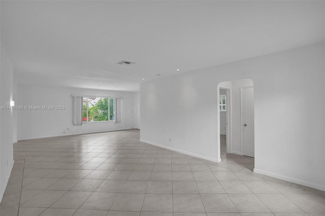 unfurnished room featuring light tile flooring