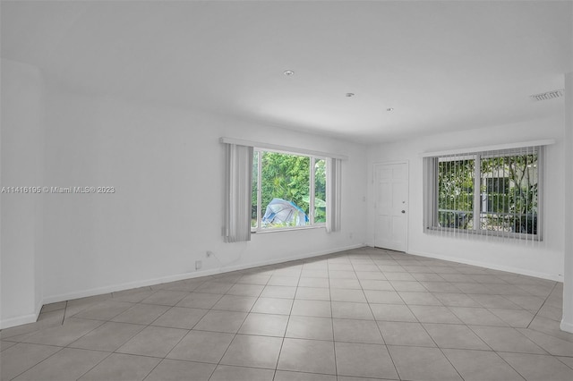 spare room featuring light tile floors