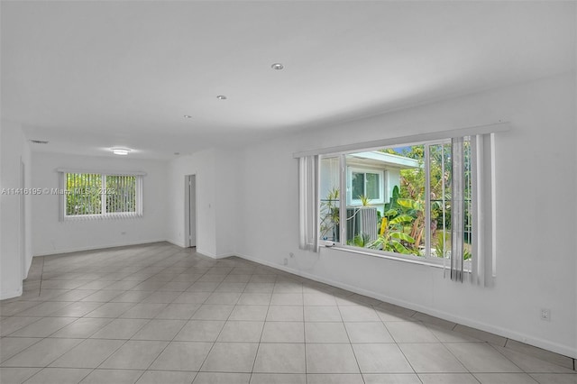 tiled empty room featuring a wealth of natural light