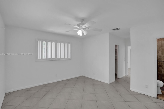 empty room featuring light tile floors and ceiling fan