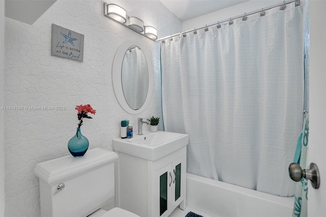 full bathroom with shower / bath combo with shower curtain, toilet, and vanity