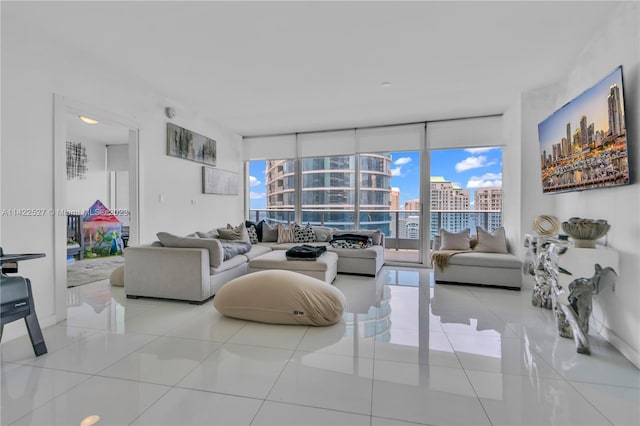 living room featuring expansive windows and light tile flooring