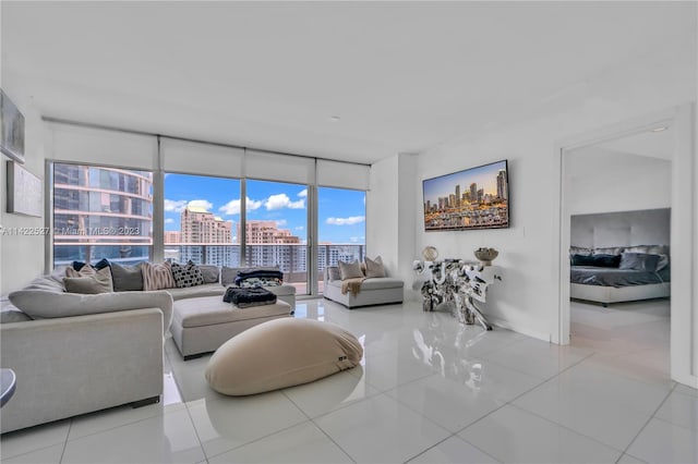 tiled living room featuring a wall of windows