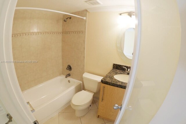 full bathroom with tiled shower / bath combo, vanity, tile flooring, and toilet