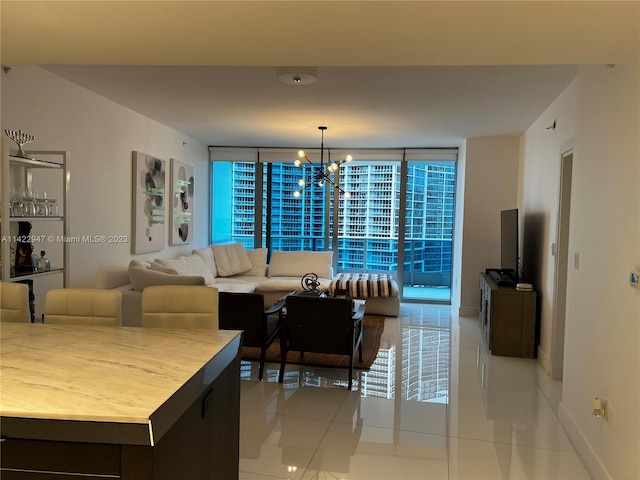 tiled living room with floor to ceiling windows, a healthy amount of sunlight, and a chandelier