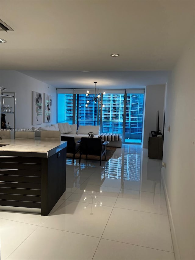 interior space with light tile floors, a notable chandelier, and hanging light fixtures