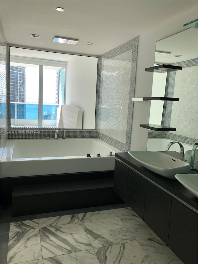 bathroom with tile flooring, vanity, and a washtub