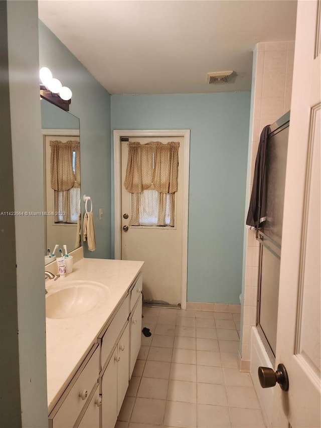 bathroom featuring shower / tub combination, vanity, and tile patterned floors