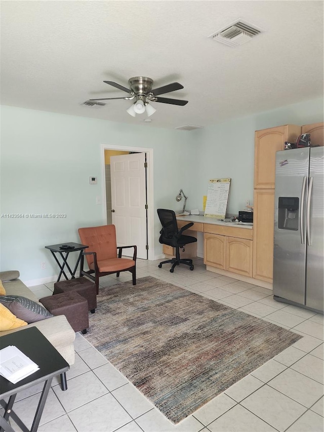 home office with light tile patterned floors and ceiling fan