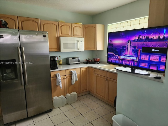 kitchen featuring stainless steel fridge and light tile patterned floors