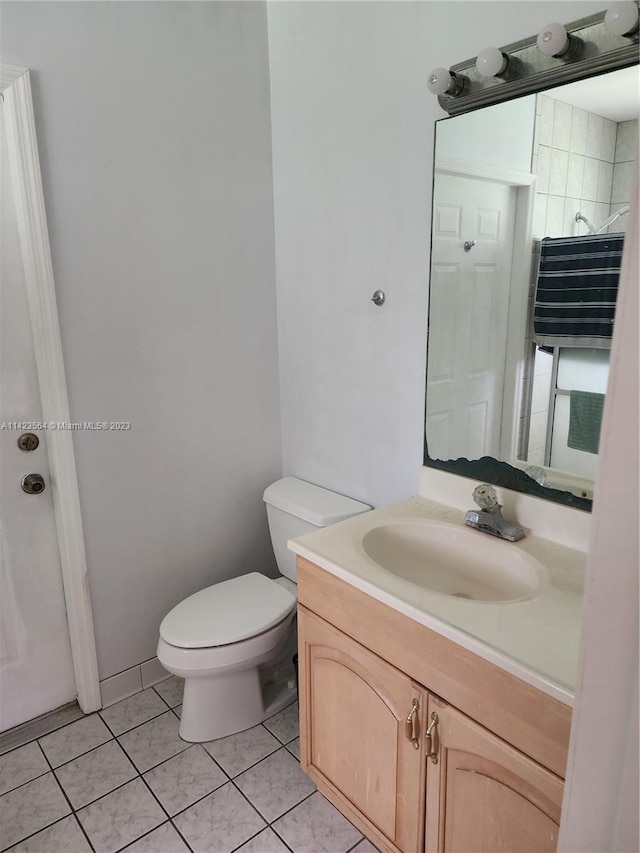 bathroom featuring vanity, radiator heating unit, tile patterned flooring, and toilet