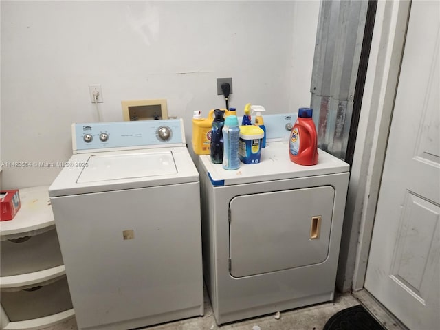 clothes washing area with washing machine and dryer