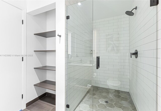 bathroom featuring walk in shower and toilet