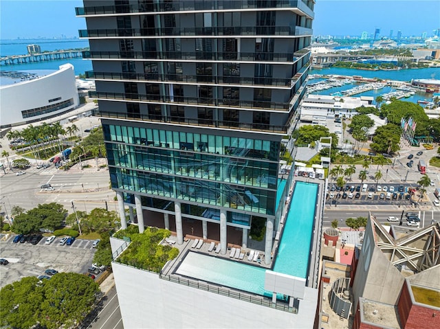 view of building exterior with a water view and central air condition unit