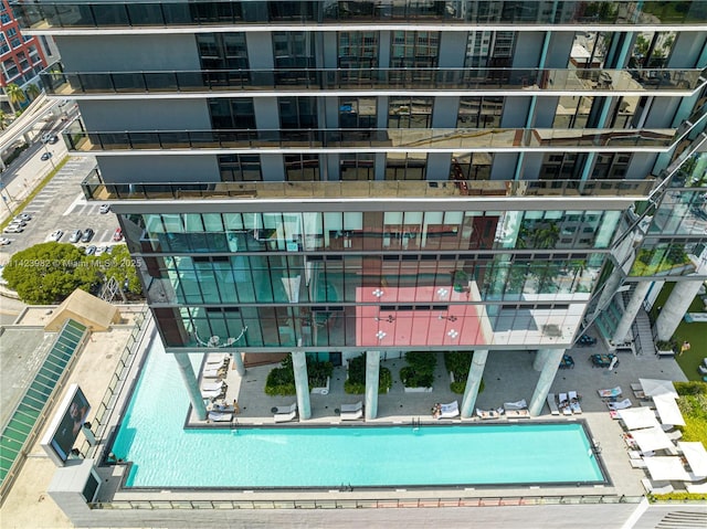 view of building exterior featuring a community pool