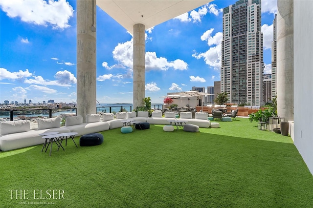 view of yard featuring a water view and an outdoor living space