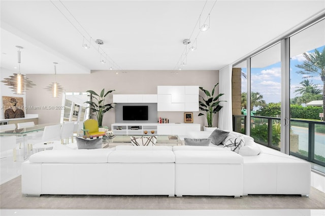 tiled living room with rail lighting and expansive windows