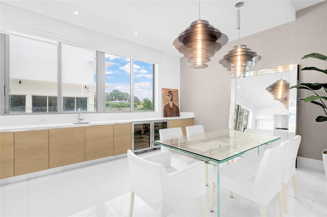 dining room with light tile patterned flooring, sink, and wine cooler