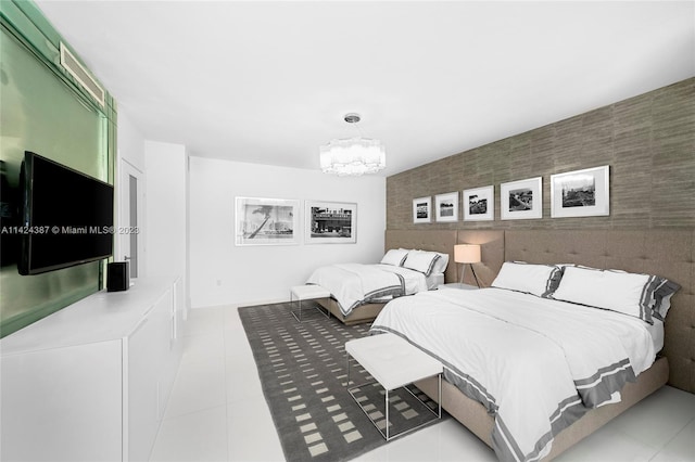 tiled bedroom with a notable chandelier