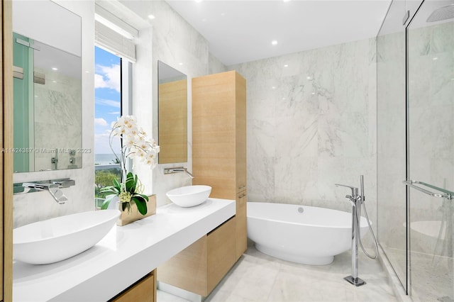 bathroom with vanity, independent shower and bath, and tile walls