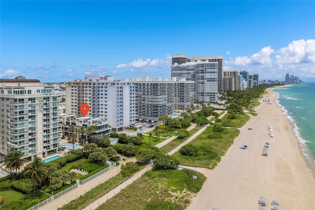 aerial view with a water view and a beach view