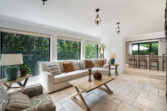 living room with light tile patterned floors, plenty of natural light, and ornamental molding