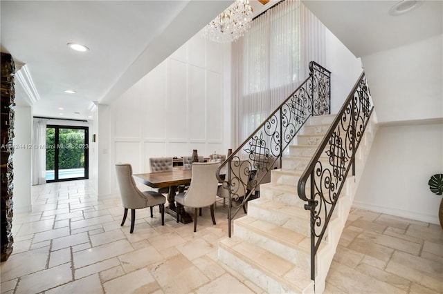 staircase featuring a notable chandelier and tile patterned flooring