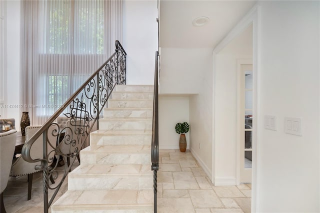 stairway featuring tile patterned flooring