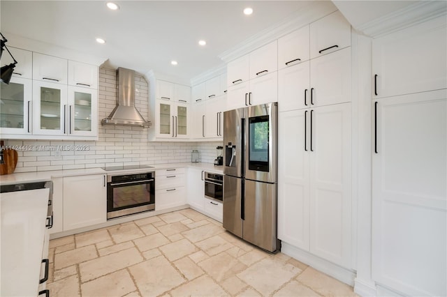 kitchen with decorative backsplash, stainless steel appliances, light tile patterned floors, and wall chimney range hood