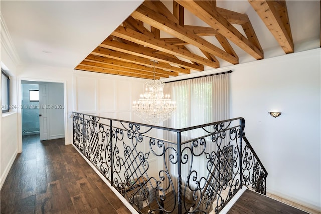 hall featuring a notable chandelier, lofted ceiling, hardwood / wood-style flooring, and a wealth of natural light