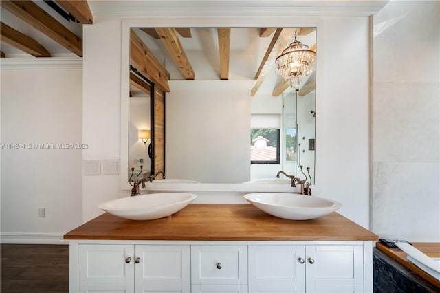 bathroom with hardwood / wood-style floors, double vanity, a chandelier, and beam ceiling