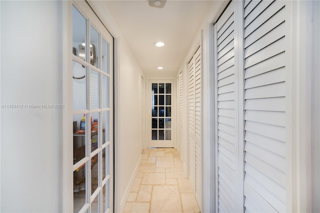 hallway featuring french doors and light tile patterned floors