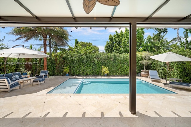 view of pool featuring ceiling fan, a patio, and an outdoor hangout area