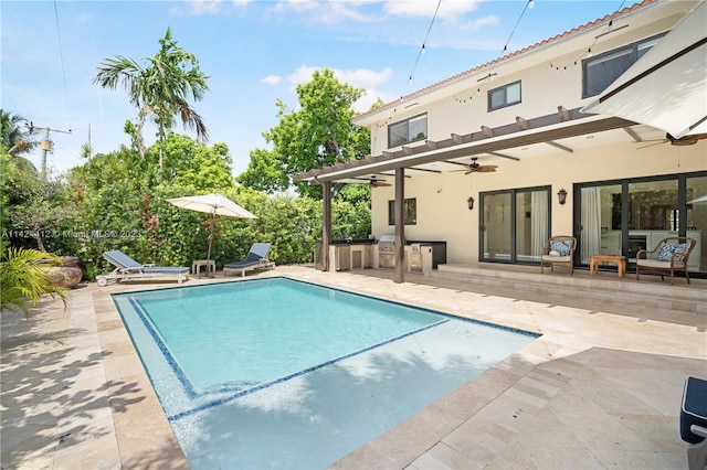 view of swimming pool featuring a patio area, area for grilling, and ceiling fan