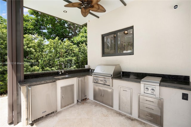 view of patio / terrace featuring exterior kitchen, ceiling fan, sink, and area for grilling