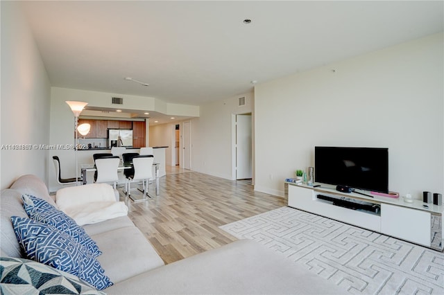 living room with light hardwood / wood-style flooring