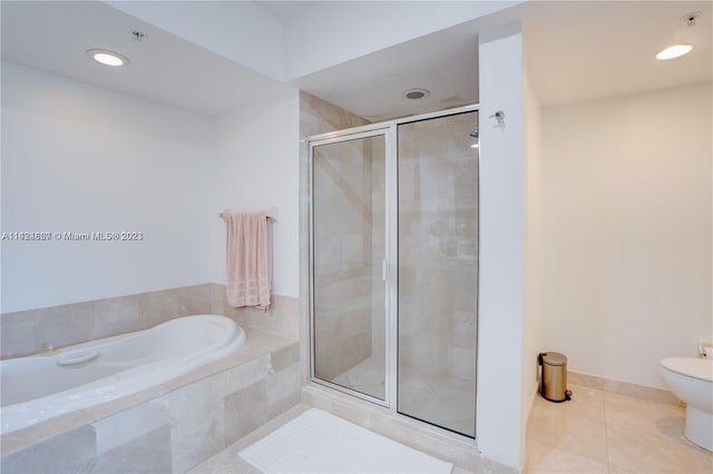 bathroom featuring tile flooring, shower with separate bathtub, and toilet